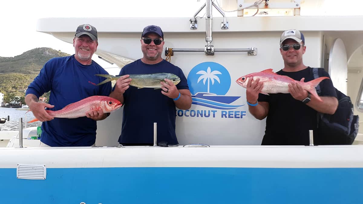 Coconut Reef Fishing - Guests holding up the best of the day's catch.