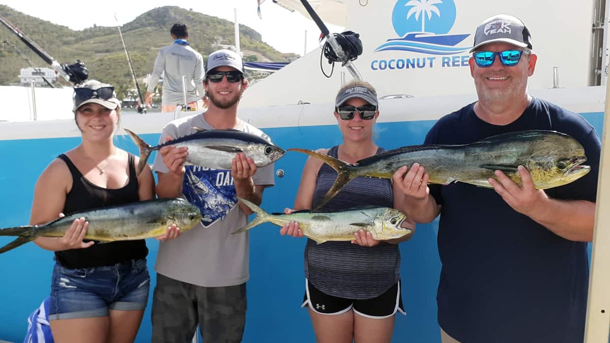 Happy guests holding up the days catch. Several Mahi-Mahi and a nice Tuna.